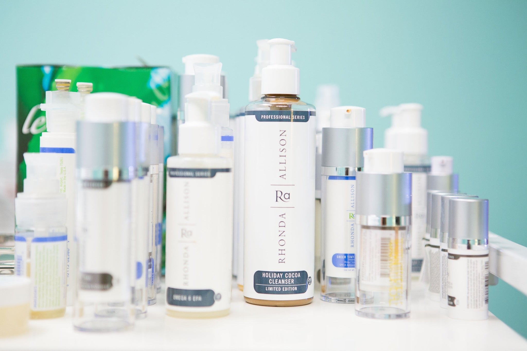 collection of rhonda allison skin care products inside porcelain skin treatment room